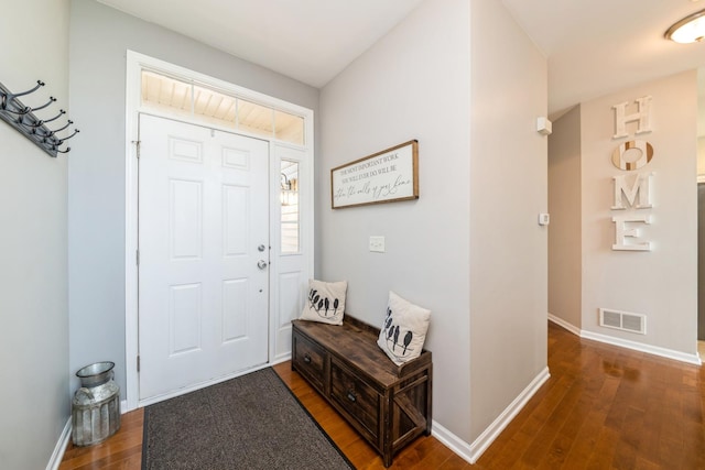 entryway with wood finished floors and baseboards