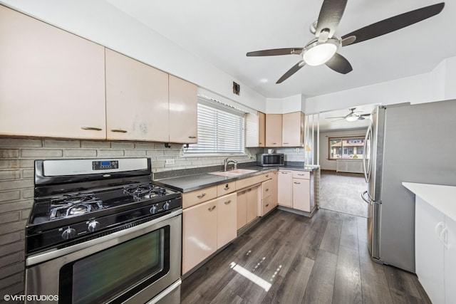 1535 S 56th Ct, Cicero, IL 60804 - kitchen with stainless steel appliances, ceiling fan, tasteful backsplash, dark wood-style floors, and dark countertops
