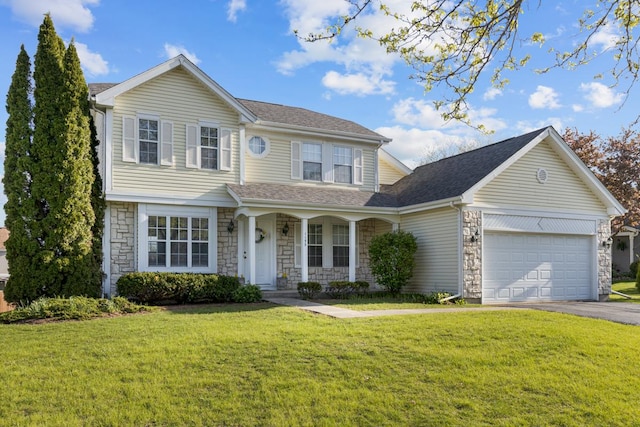 view of front of house featuring stone siding, covered porch, a front yard, driveway, and a garage