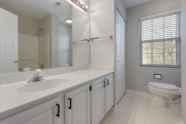 full bath with toilet, tile patterned flooring, vanity, baseboards, and a shower