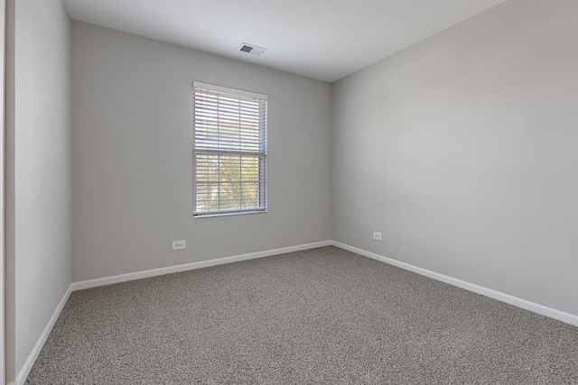 carpeted spare room with baseboards
