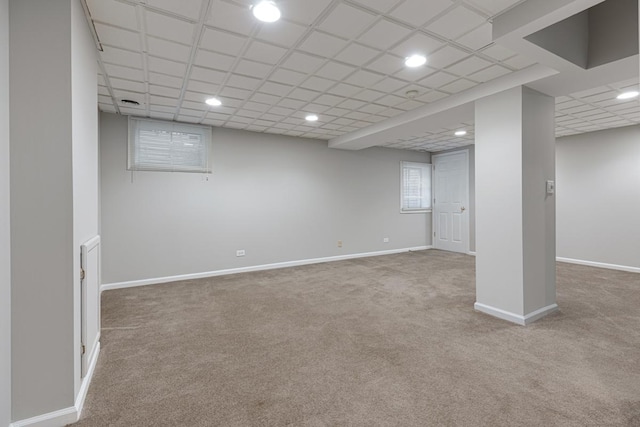 basement featuring carpet flooring and baseboards