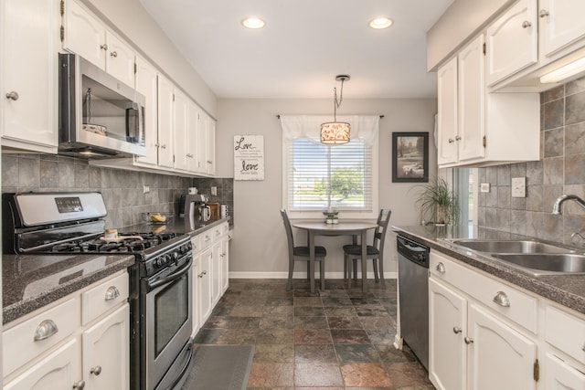 kitchen with appliances with stainless steel finishes, a sink, baseboards, white cabinetry, and recessed lighting