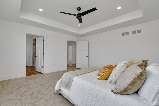 1051 Kinley Dr, New Lenox, IL 60451 - carpeted bedroom featuring a tray ceiling, recessed lighting, baseboards, a ceiling fan, and ensuite bathroom