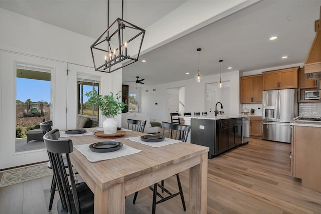 1051 Kinley Dr, New Lenox, IL 60451 - dining area featuring light wood-type flooring, recessed lighting, a ceiling fan, and a chandelier