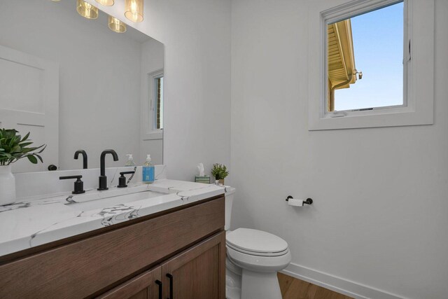 1051 Kinley Dr, New Lenox, IL 60451 - bathroom featuring toilet, baseboards, wood finished floors, and vanity