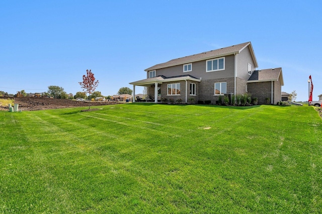 1051 Kinley Dr, New Lenox, IL 60451 - rear view of house featuring a lawn and brick siding