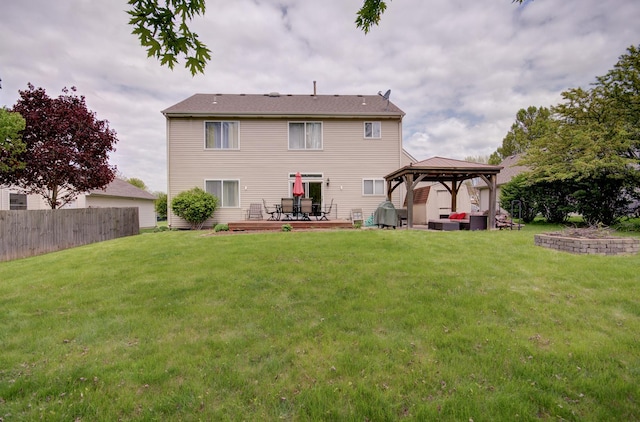 rear view of property featuring a gazebo and a patio area