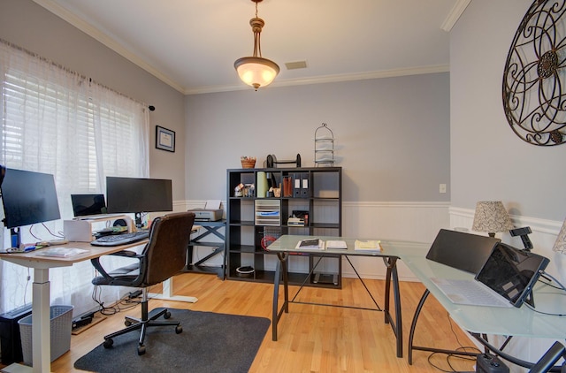 office with wood finished floors, wainscoting, and crown molding