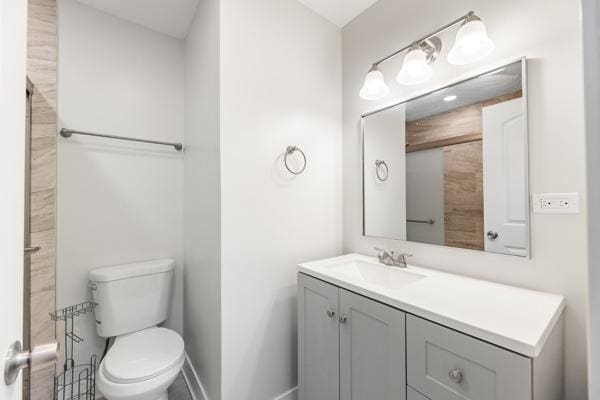15100 Hamlin Ave, Midlothian, IL 60445 - bathroom featuring toilet, baseboards, and vanity