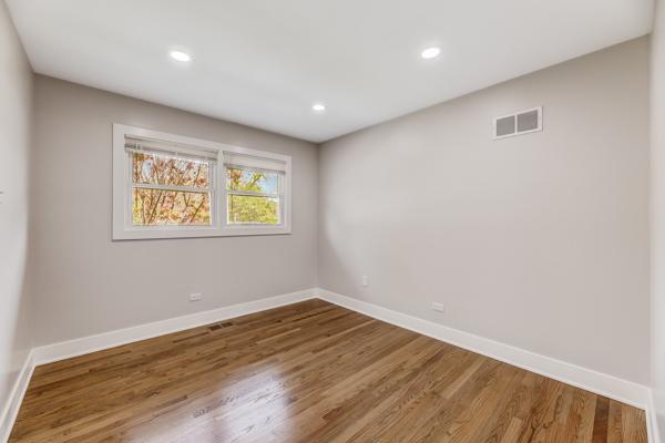 15100 Hamlin Ave, Midlothian, IL 60445 - spare room featuring baseboards, wood finished floors, and recessed lighting