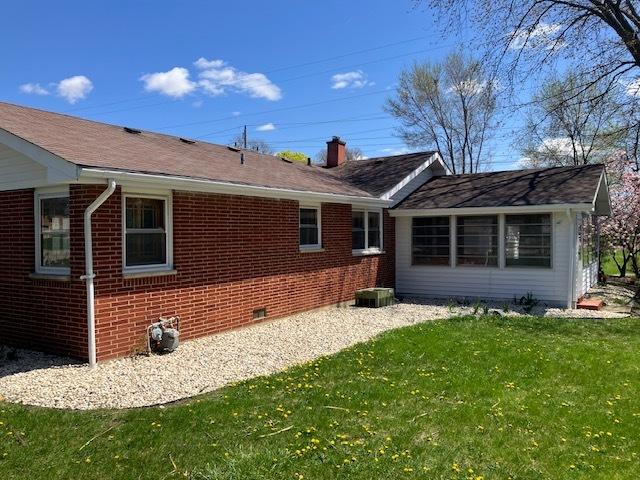 1336 Ardmore Dr, Round Lake Beach, IL 60073 - rear view of property featuring brick siding, a yard, a chimney, and crawl space