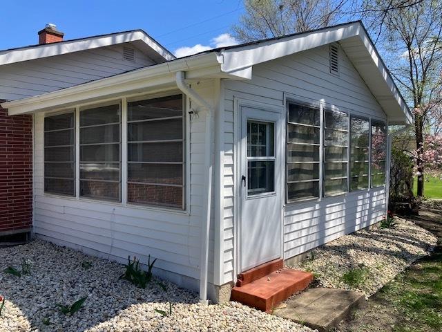 1336 Ardmore Dr, Round Lake Beach, IL 60073 - view of home's exterior with a sunroom and a chimney