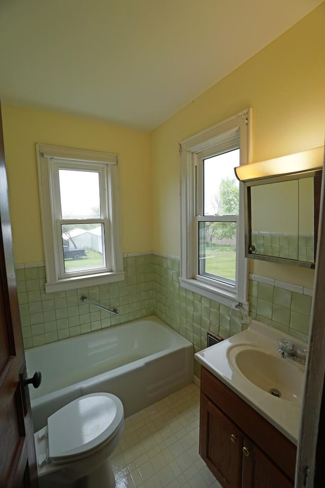 1511 Becker School Rd, Freeport, IL 61032 - full bathroom featuring plenty of natural light, a garden tub, vanity, tile walls, and toilet