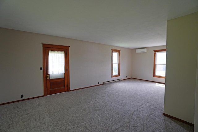 1511 Becker School Rd, Freeport, IL 61032 - carpeted empty room featuring a baseboard heating unit, a wall mounted AC, and baseboards
