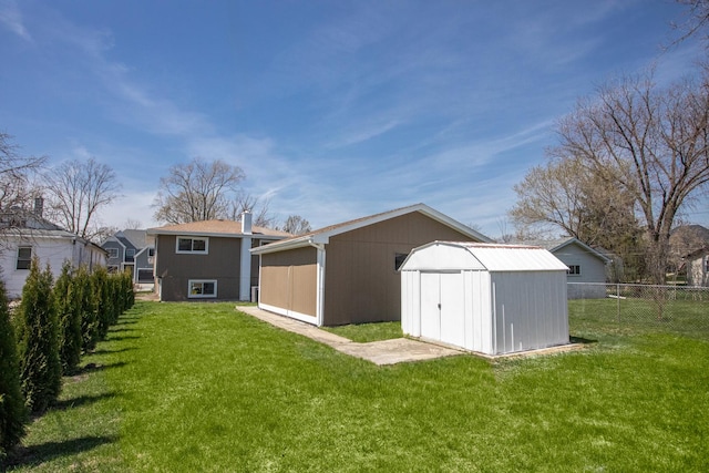 rear view of house with a storage shed, an outbuilding, and a chimney