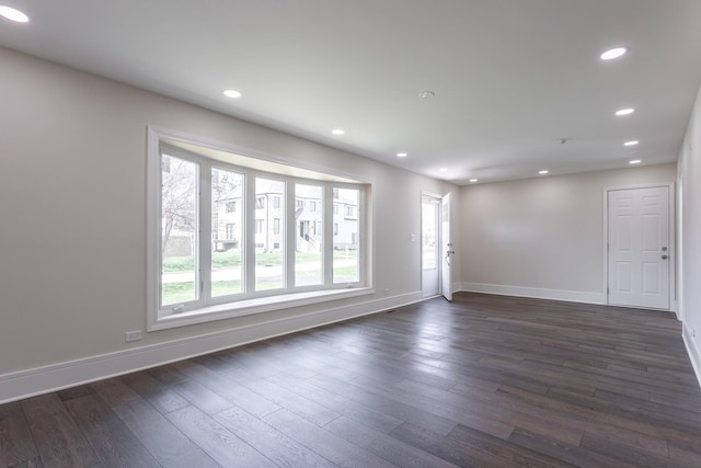 unfurnished room with baseboards, dark wood-style floors, and recessed lighting