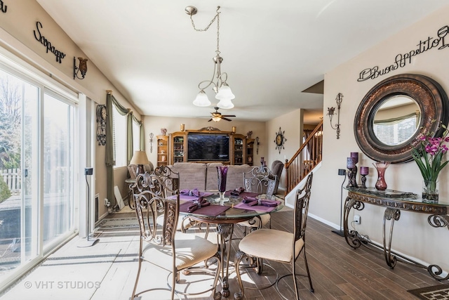 3313 Christopher Ln, Johnsburg, IL 60051 - dining space featuring a chandelier, wood finished floors, baseboards, and stairway