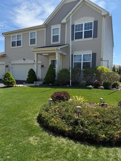 3313 Christopher Ln, Johnsburg, IL 60051 - view of front of home with an attached garage and a front lawn