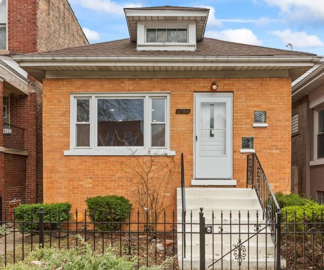 6954 S Prairie Ave, Chicago, IL 60637 - doorway to property with brick siding and a shingled roof