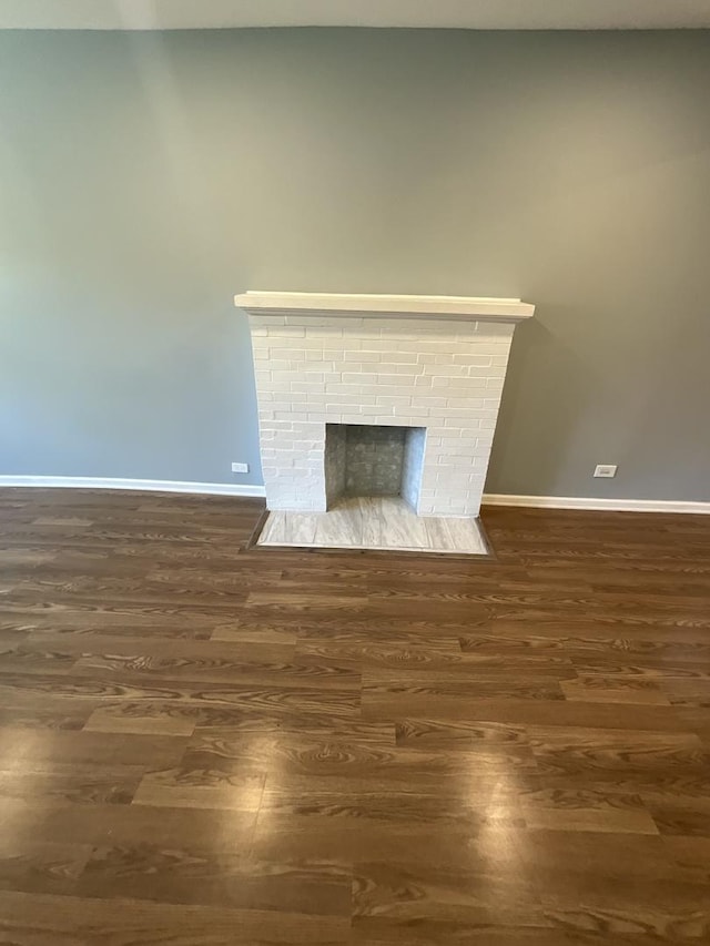 6954 S Prairie Ave, Chicago, IL 60637 - detailed view of wood finished floors, baseboards, and a fireplace