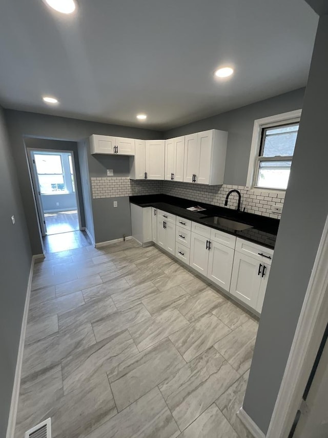 6954 S Prairie Ave, Chicago, IL 60637 - kitchen with a sink, light marble finish flooring, healthy amount of natural light, tasteful backsplash, and recessed lighting