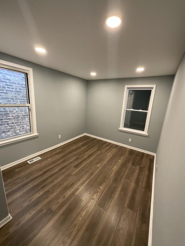 6954 S Prairie Ave, Chicago, IL 60637 - empty room featuring dark wood-style flooring, recessed lighting, and baseboards