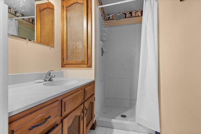 bathroom with a shower stall and vanity
