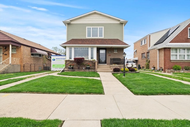 11026 S S Ave H, Chicago, IL 60617 - view of front of house featuring a front yard, central AC unit, and brick siding