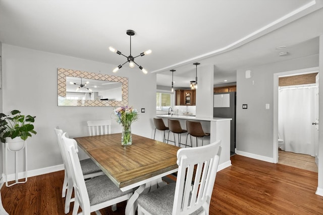 11026 S S Ave H, Chicago, IL 60617 - dining area with baseboards, a chandelier, and wood finished floors