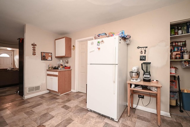 1423 Victoria Ave, North Chicago, IL 60064 - kitchen featuring freestanding refrigerator, stone finish floors, and baseboards