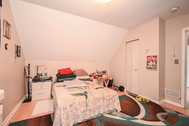 1423 Victoria Ave, North Chicago, IL 60064 - bedroom with lofted ceiling, wood finished floors, and baseboards