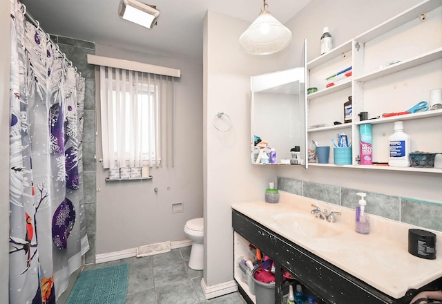 1911 Elizabeth Ave, North Chicago, IL 60064 - bathroom featuring toilet, baseboards, vanity, and curtained shower