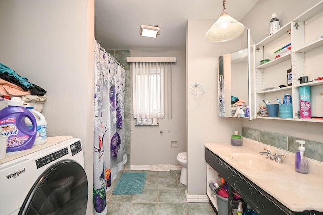 1911 Elizabeth Ave, North Chicago, IL 60064 - full bathroom featuring washer / dryer, toilet, baseboards, and a shower with curtain