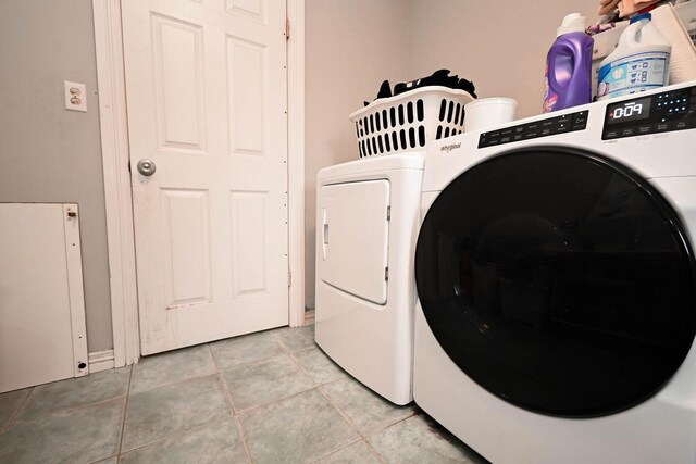 1911 Elizabeth Ave, North Chicago, IL 60064 - washroom with washer and clothes dryer and light tile patterned floors