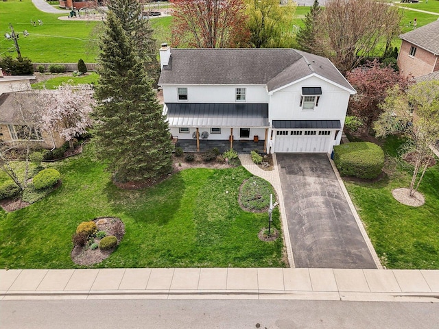 635 Ambleside Dr, Deerfield, IL 60015 - view of front of home featuring a garage, driveway, a chimney, and a front lawn