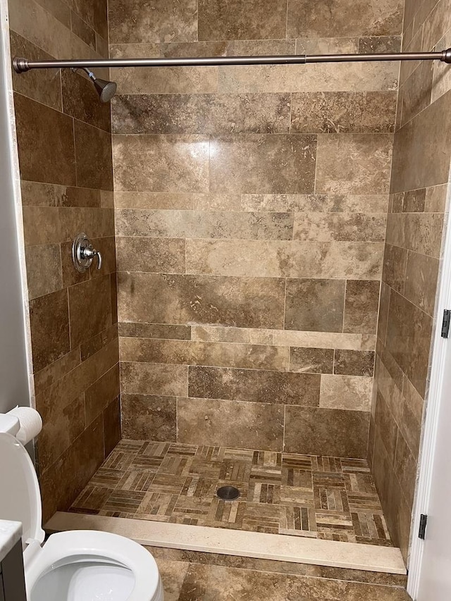full bathroom with toilet and a stall shower
