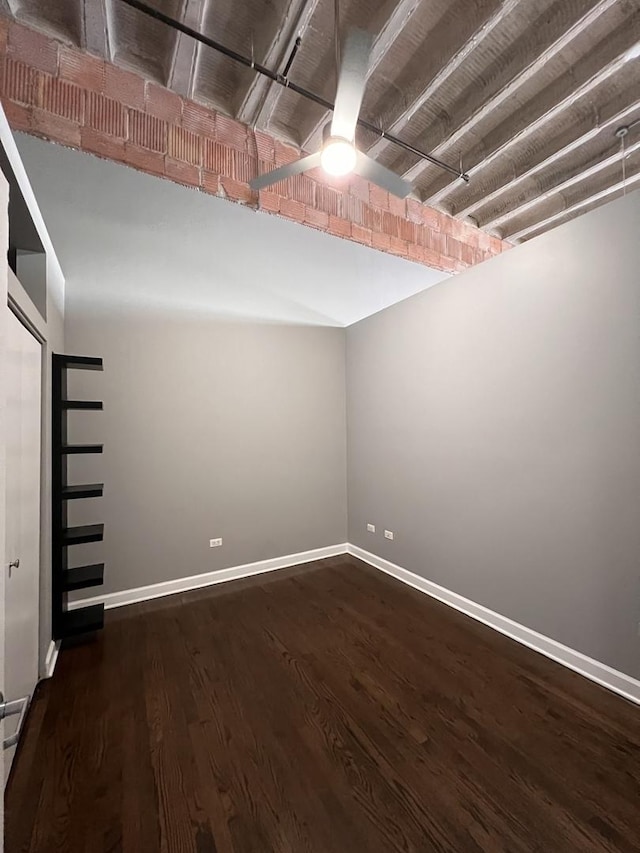 basement featuring wood finished floors and baseboards