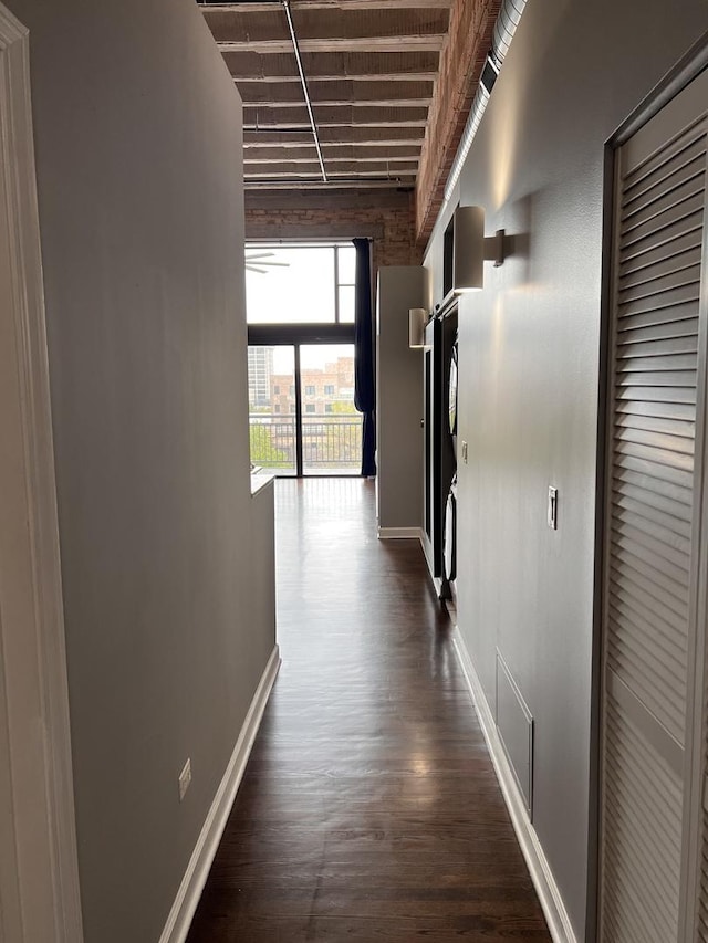 hall with baseboards and dark wood finished floors
