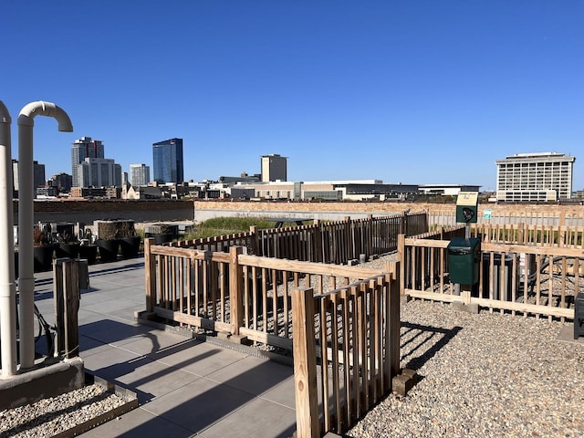 surrounding community featuring fence and a skyline view