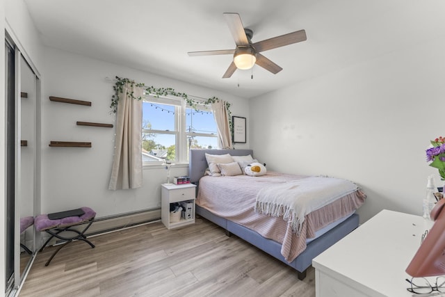 bedroom with light wood-style floors, a closet, and ceiling fan