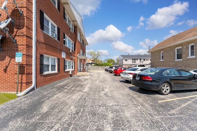 uncovered parking lot with a residential view
