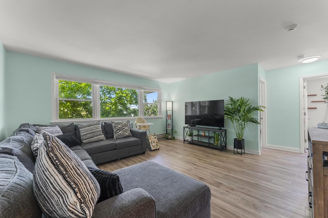 living room featuring light wood-type flooring and baseboards
