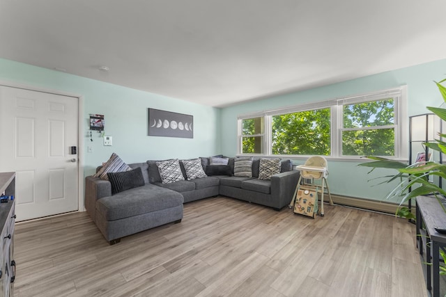 living area featuring light wood-style flooring and baseboard heating