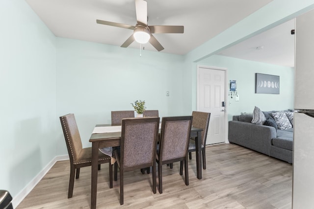 dining area featuring light wood-style flooring and ceiling fan