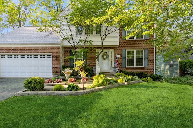 772 Red Oak Dr, Bartlett, IL 60103 - view of front facade featuring brick siding, a front lawn, asphalt driveway, and a garage