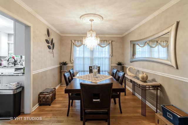 772 Red Oak Dr, Bartlett, IL 60103 - dining space featuring a chandelier, light wood-style floors, plenty of natural light, and ornamental molding