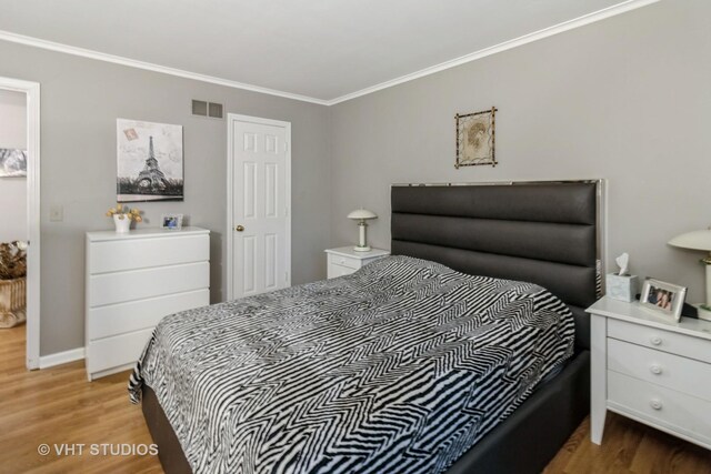 772 Red Oak Dr, Bartlett, IL 60103 - bedroom with wood finished floors, ornamental molding, and baseboards