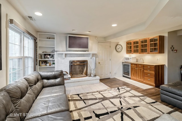 772 Red Oak Dr, Bartlett, IL 60103 - living room with beverage cooler, a fireplace, wood finished floors, recessed lighting, and bar area
