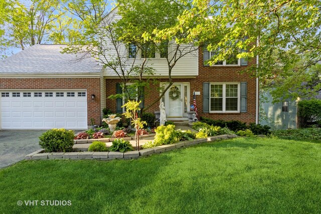 772 Red Oak Dr, Bartlett, IL 60103 - view of front of home featuring brick siding, a front yard, asphalt driveway, a garage, and roof with shingles